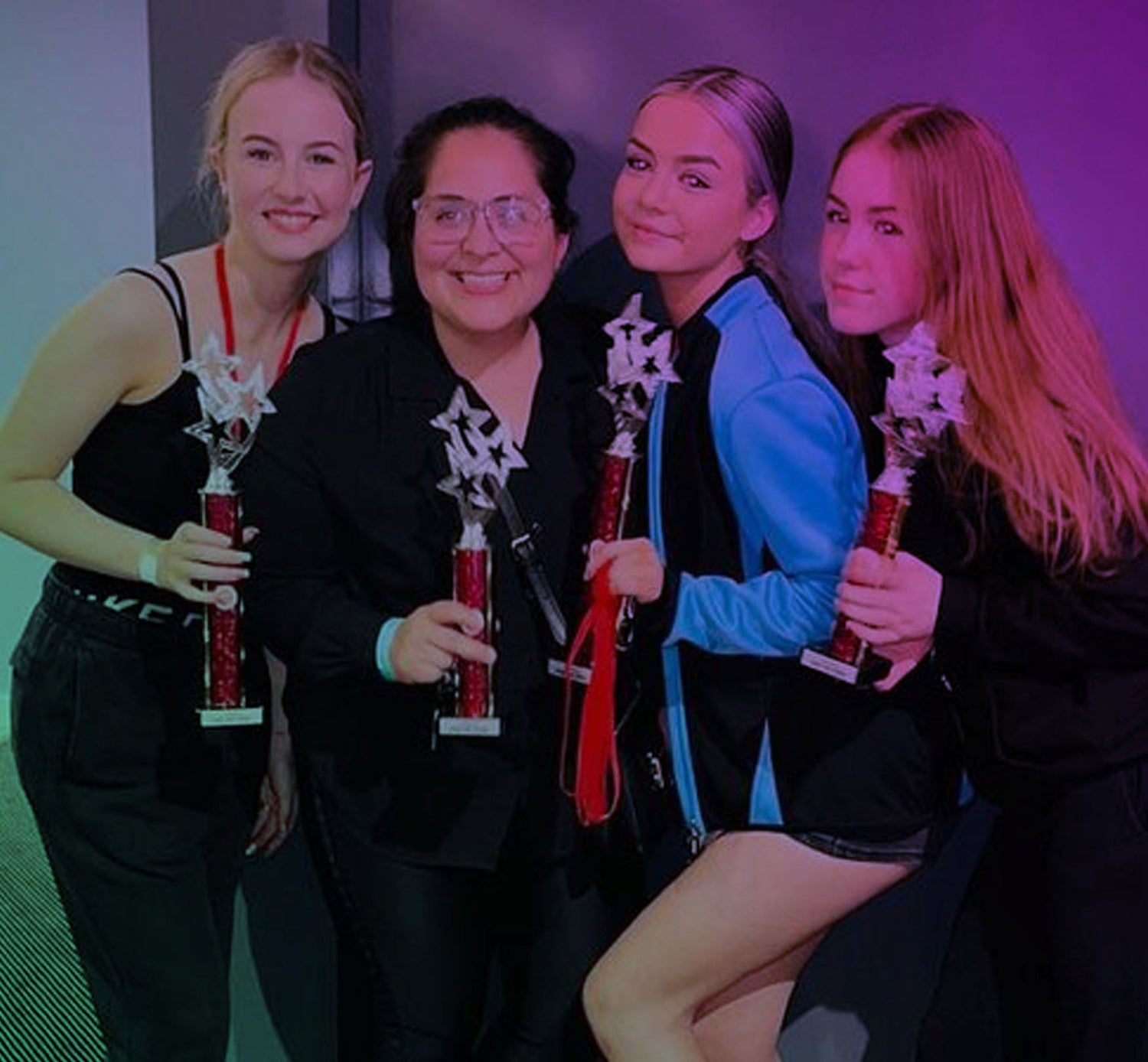teacher and students holding dancing trophy